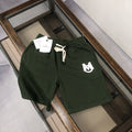 Dark green drawstring shorts with white logo on left thigh