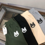 Drawstring shorts in dark green, black, and light beige with white logos