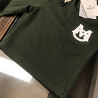 Dark green shorts with white logo emblem on front pocket area
