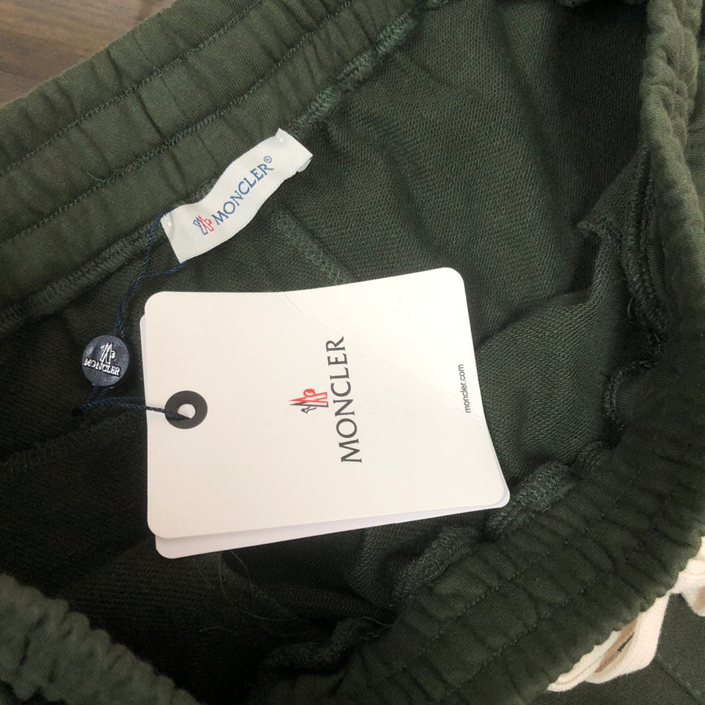 Dark green shorts with MONCLER tag attached inside waistband