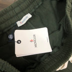 Dark green shorts with MONCLER tag attached inside waistband