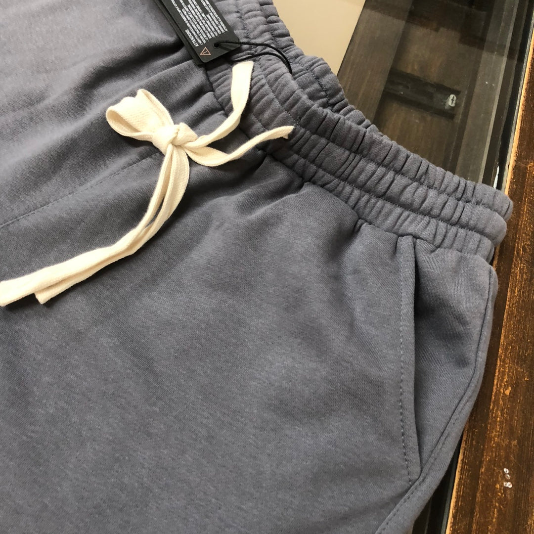 Gray sweat shorts with ribbed elastic waistband and cream drawstring