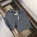 Gray drawstring shorts with elastic waistband and Stone Island logo patch
