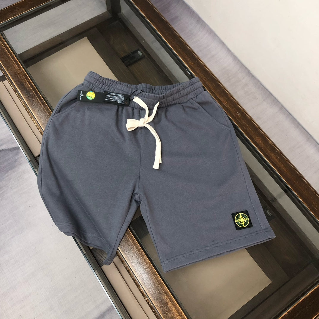 Gray drawstring shorts with elastic waistband and Stone Island logo patch
