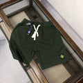 Stone Island dark green shorts with white drawstring and circular logo patch