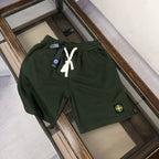 Stone Island dark green shorts with white drawstring and circular logo patch