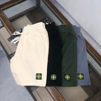 Stone Island shorts set: white, black, dark green, and blue with circular logo patch
