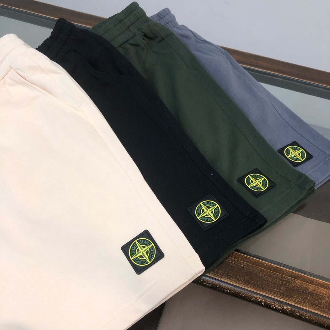 Shorts in dark colors (black, green, gray) with Stone Island logo patches