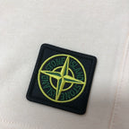 Cream fabric shorts with Stone Island logo patch on thigh