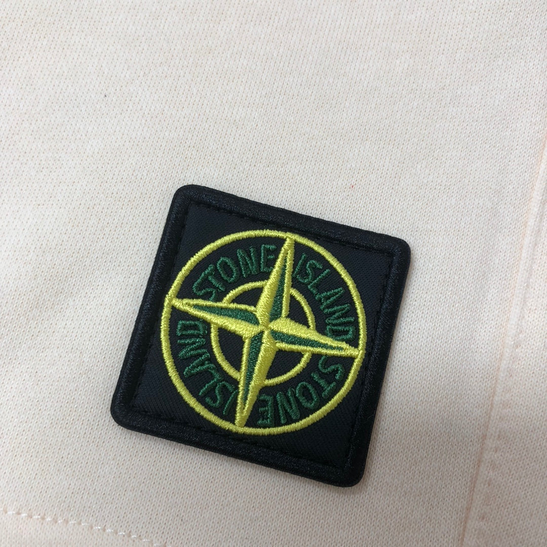 Cream fabric shorts with Stone Island logo patch on thigh