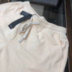 Cream drawstring shorts with elastic waistband and Stone Island logo tags