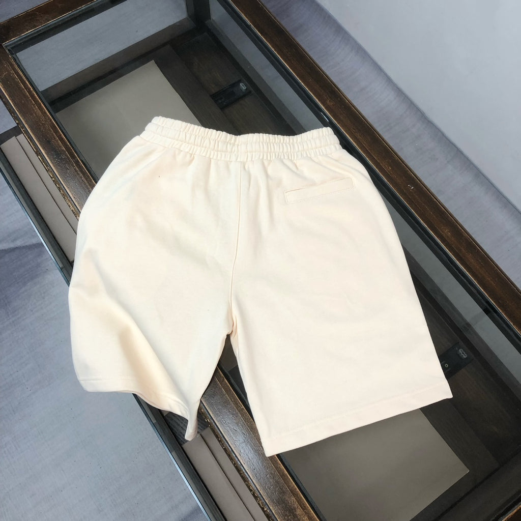 Cream drawstring shorts with elastic waistband and side seam detail