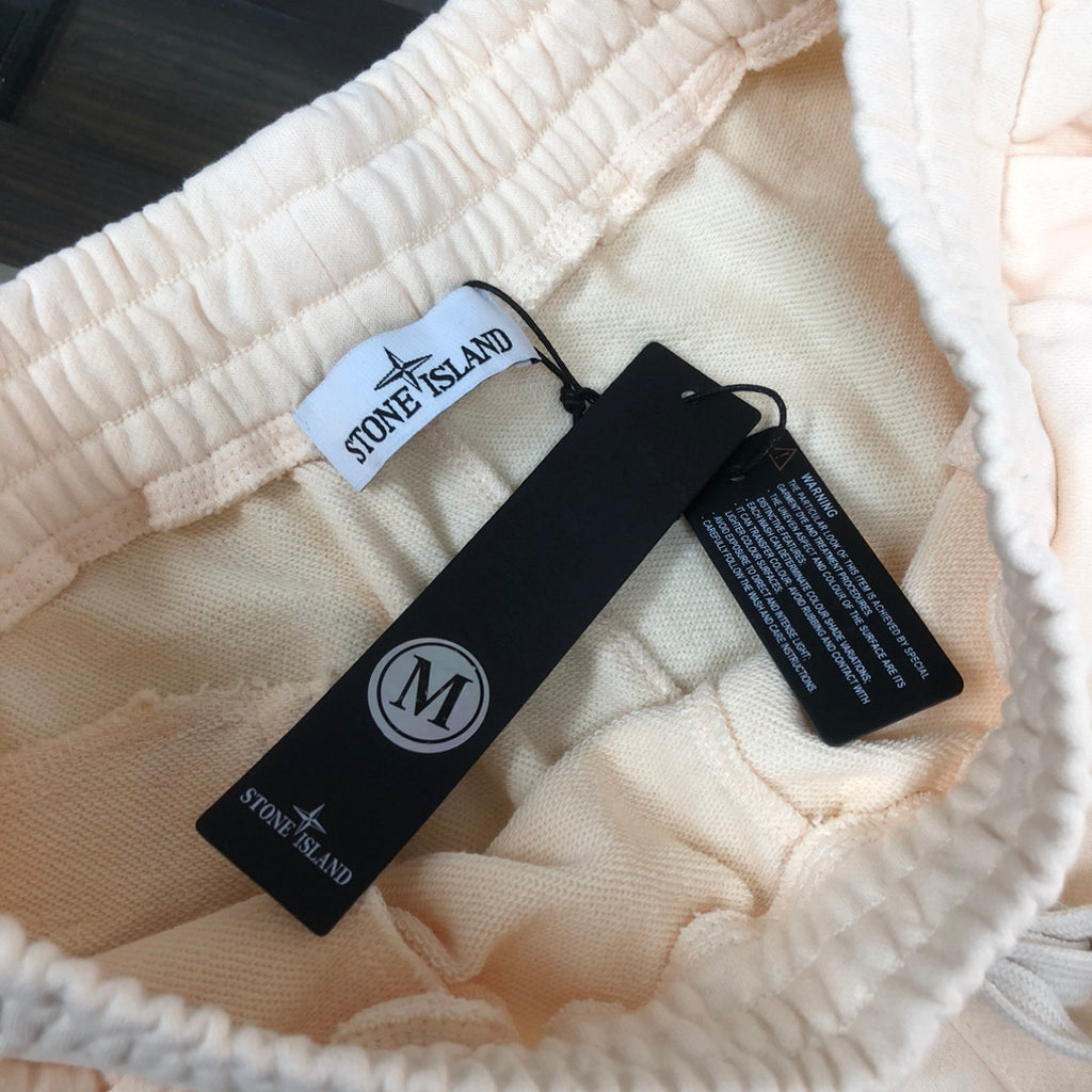 Cream shorts interior with Stone Island size tag and care labels