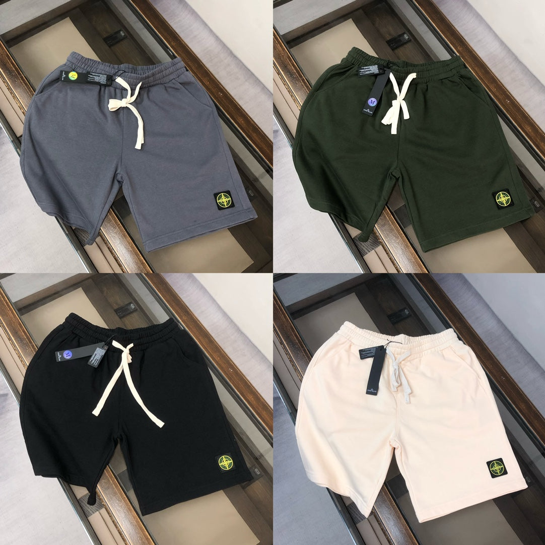Drawstring shorts in navy, dark green, black, and white with logo patches