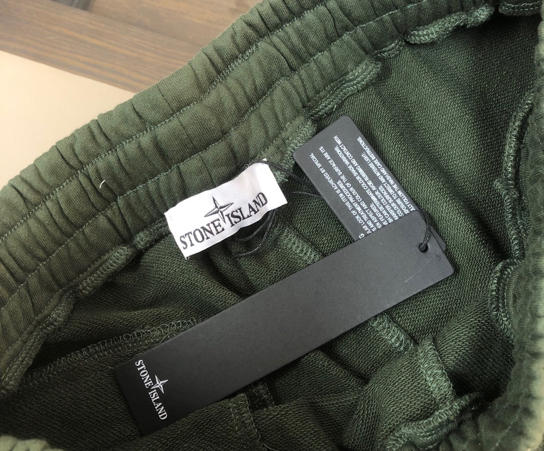 Stone Island green shorts waistband with brand tag and size label