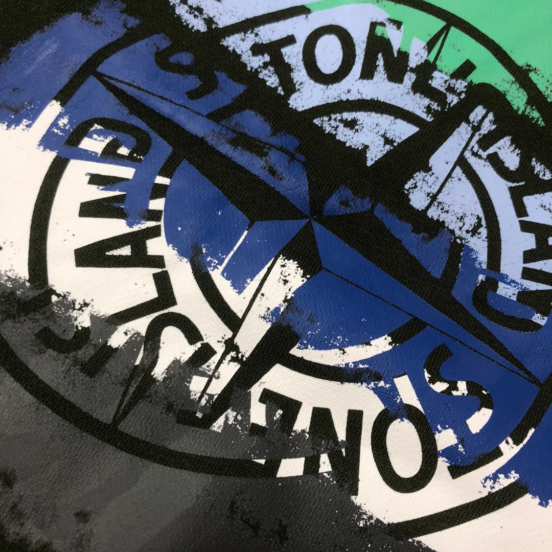 Stone Island green shorts with blue and white circular logo graphic