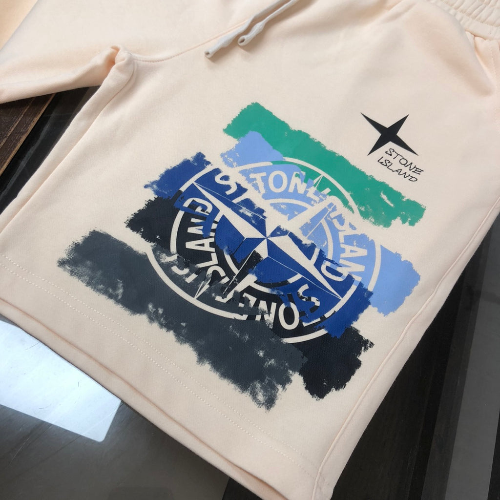 Stone Island cream shorts with large blue logo graphic and green paint stripe