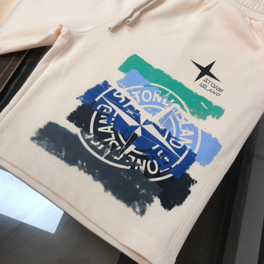 Stone Island cream shorts with large blue logo graphic and green paint stripe