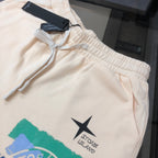 Stone Island cream shorts with elastic waist, drawstring, and star logo