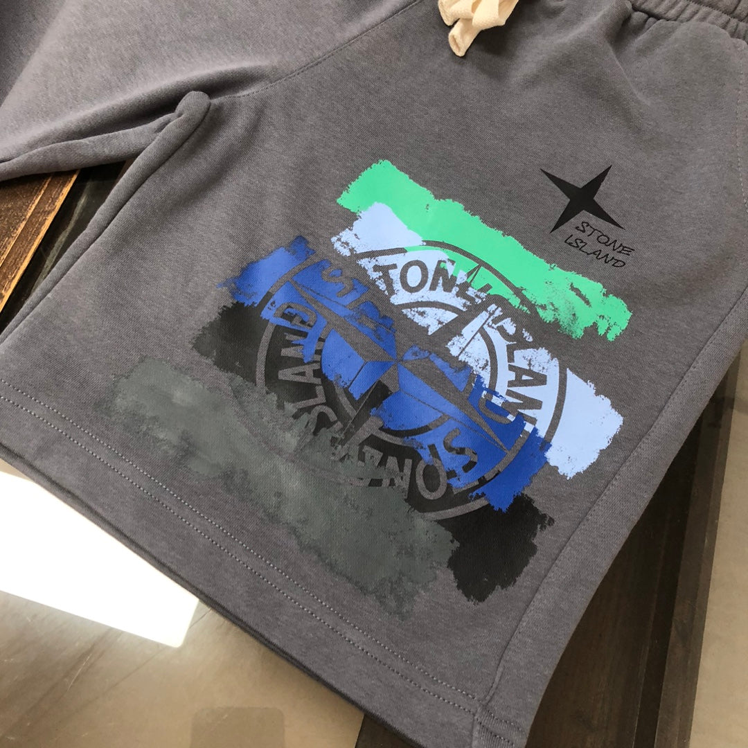 Stone Island grey shorts with large graffiti-style logo graphic and star emblem