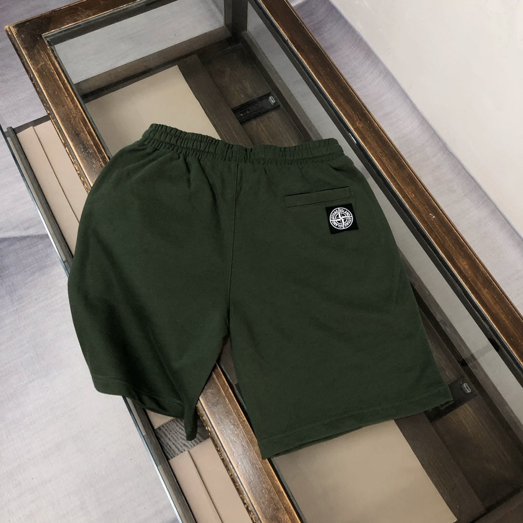 Dark green Stone Island shorts with side logo patch