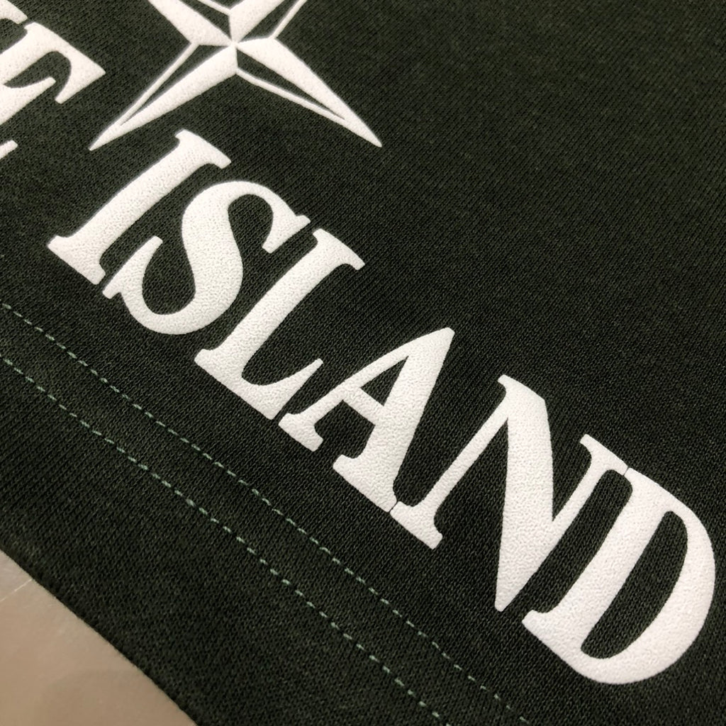 Dark green Stone Island logo print and star on shorts hem