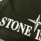 Dark green Stone Island logo print on side of shorts