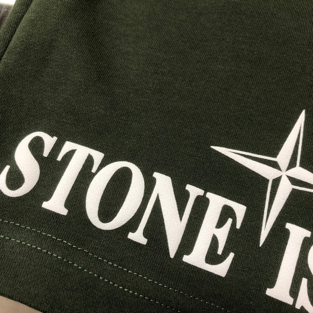 Dark green Stone Island logo print on side of shorts