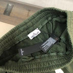 Dark green Stone Island shorts waistband with inner tags
