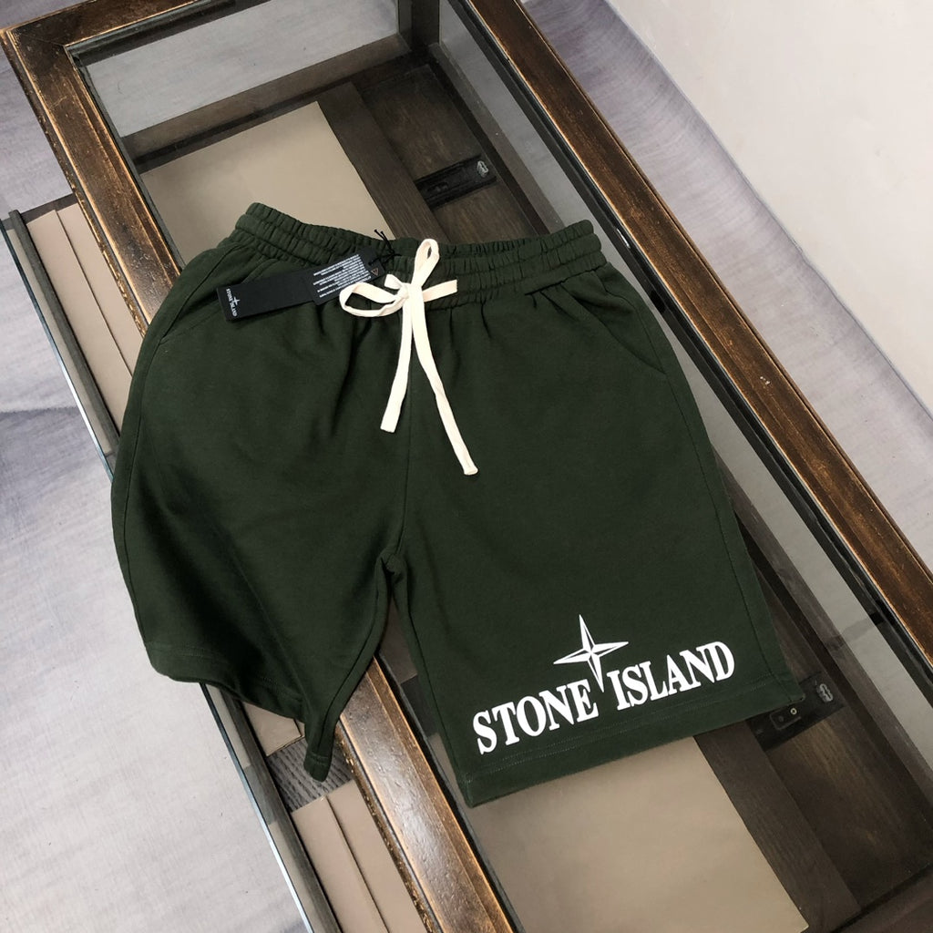 Dark green Stone Island shorts with white drawstring and front logo patch