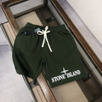 Dark green Stone Island shorts with white drawstring and front logo patch
