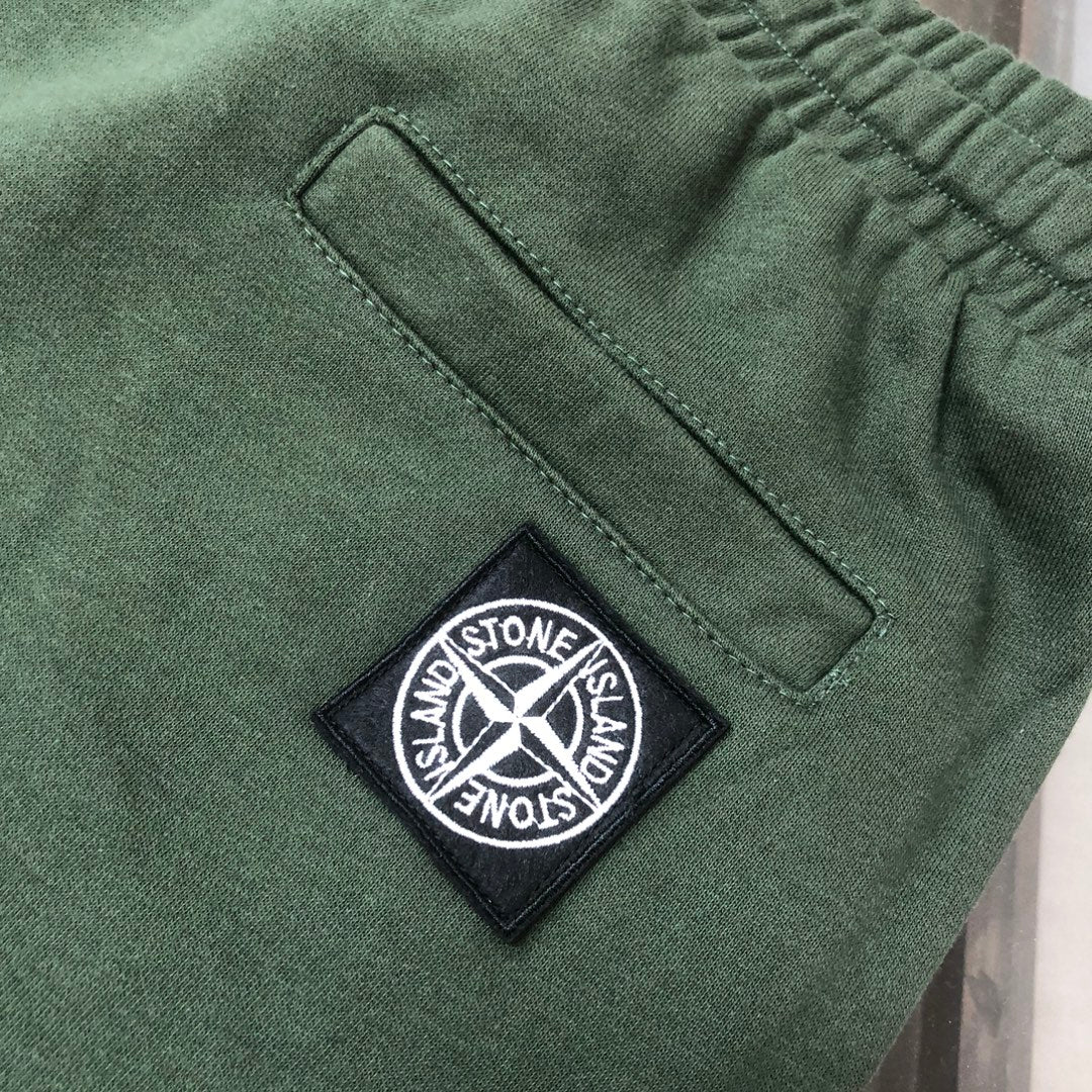 Dark green Stone Island diamond logo patch on shorts