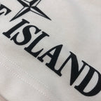 Stone Island logo print detail on off-white shorts