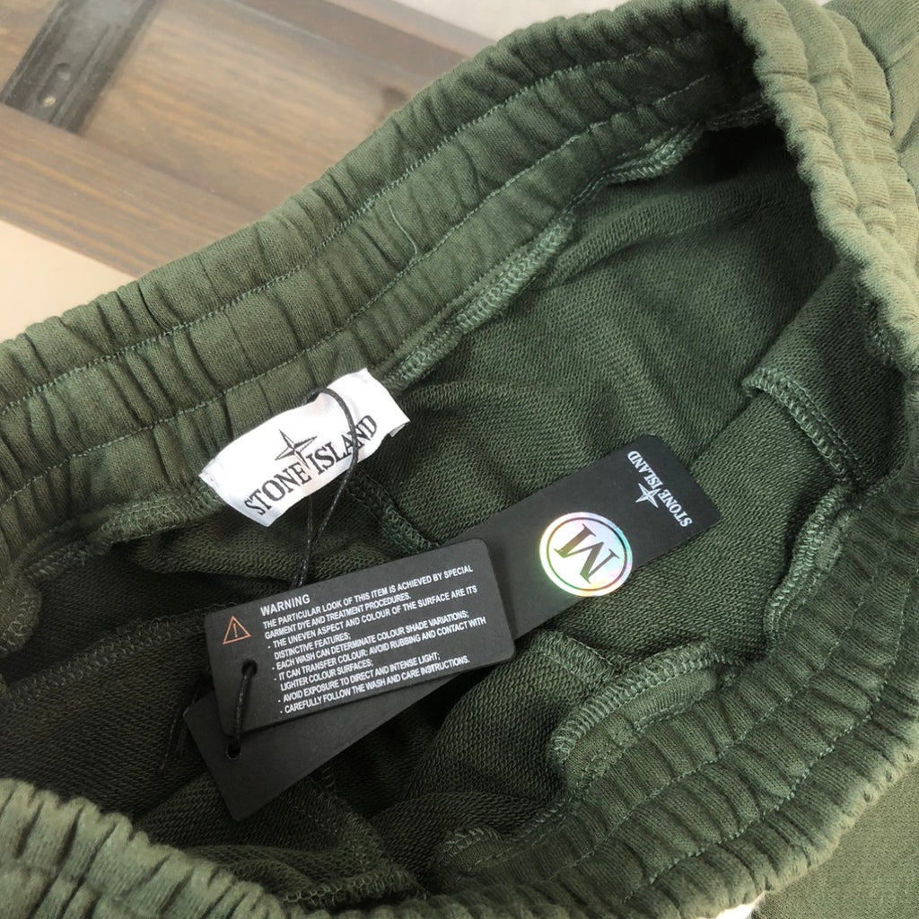 Green drawstring shorts with elastic waistband and woven brand tags inside