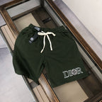 Dark green drawstring shorts with 'DIOR' logo and front pockets