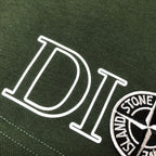 Green fabric shorts with large 'DIOR' lettering and circular logo patch