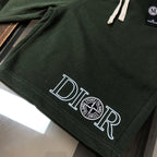 Dark green shorts hem with large 'DIOR' print logo and stitched detail