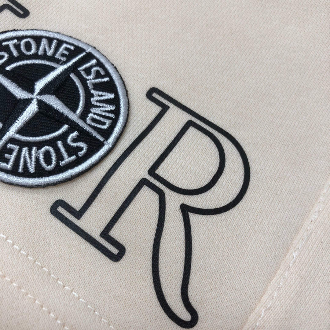 Stone Island off-white shorts close-up of Dior logo and Stone Island emblem