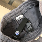 Interior view of Stone Island gray shorts with elastic waistband and size tag