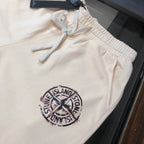 Cream Stone Island shorts with elastic waistband and large circular logo patch
