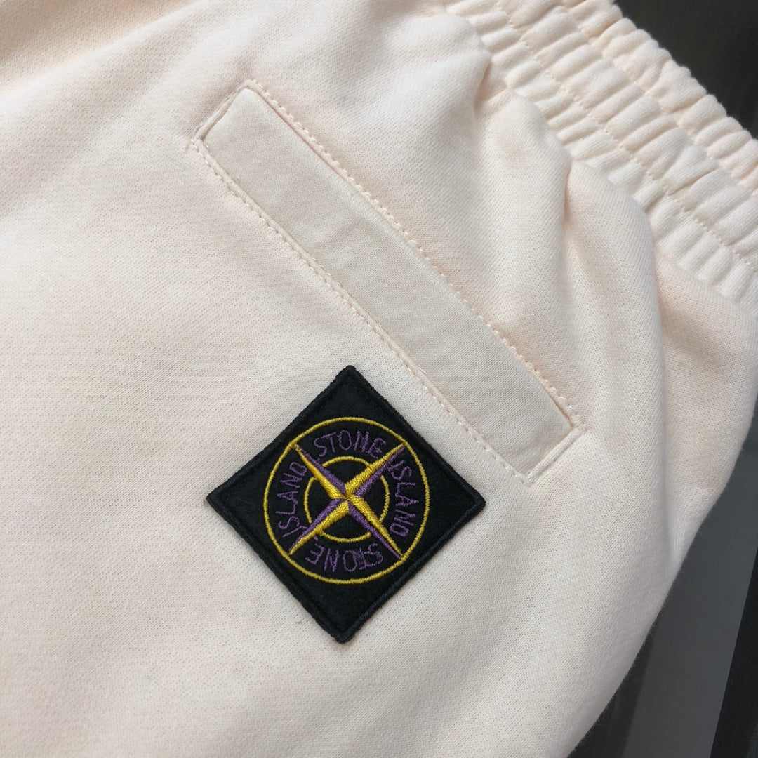 Cream Stone Island logo patch on shorts fabric near an inner seam