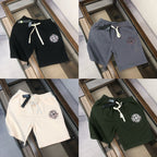 Assorted Stone Island logo shorts in black, gray, white, and dark green, drawstring waist