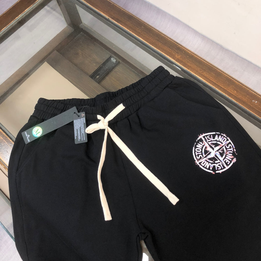 Stone Island black shorts with white drawstring and circular logo patch on leg