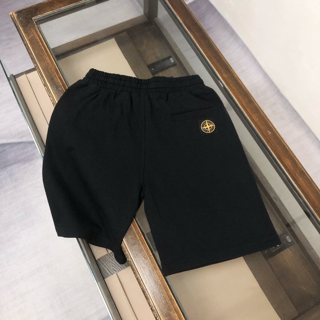 Stone Island black shorts with small circular badge on leg