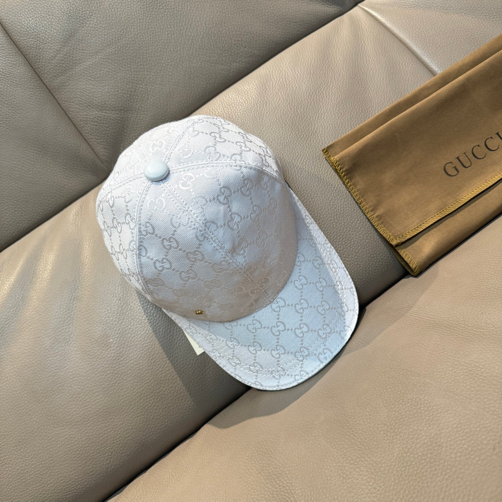 White Gucci cap with GG monogram pattern and light blue button on top