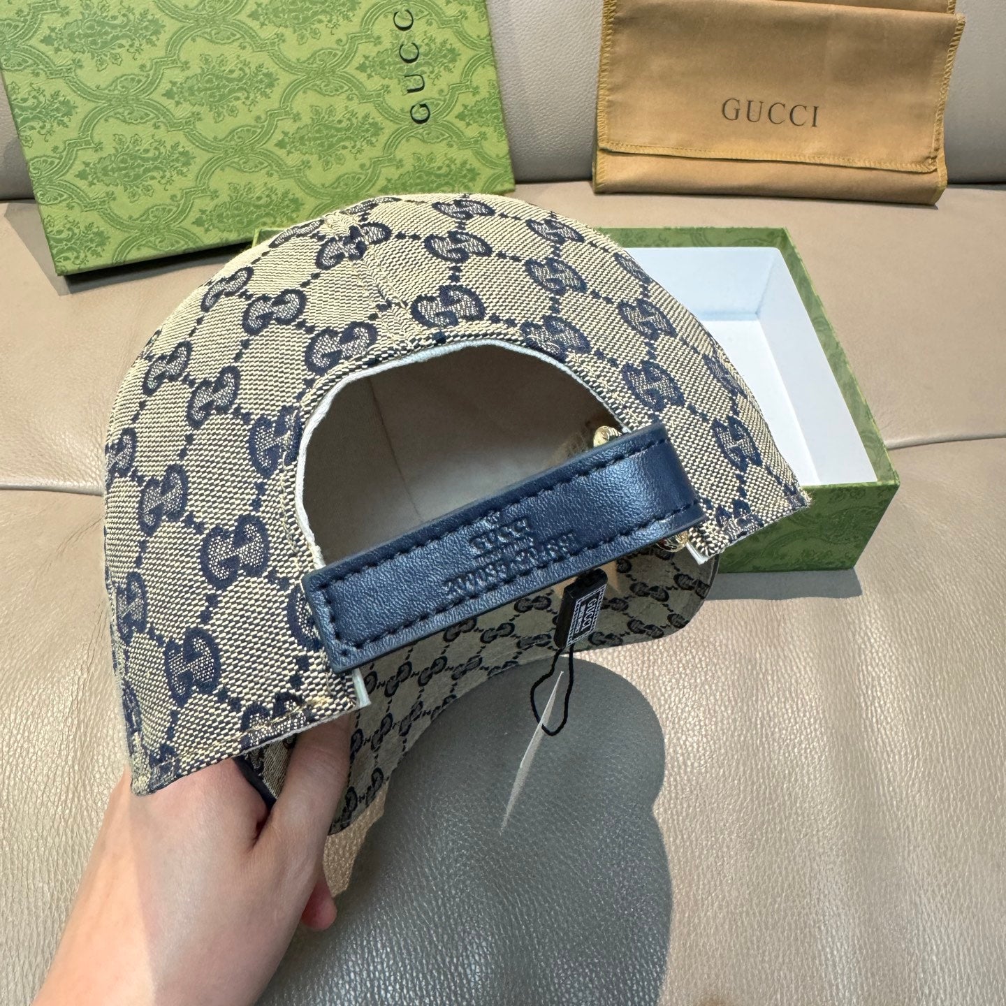 GG-pattern baseball cap underside with adjustable strap and blue trim