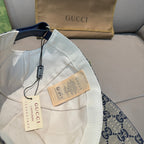 White baseball cap with GG trim, blue strap, and hang tags
