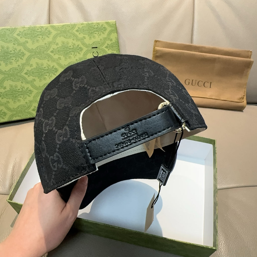 Black GG monogram cap back with adjustable strap and metal buckle.