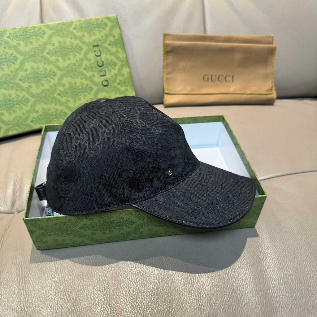 Black GG monogram baseball cap with curved brim and gold-tone logo detail.