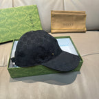 Black GG monogram baseball cap with curved brim and gold-tone logo detail.